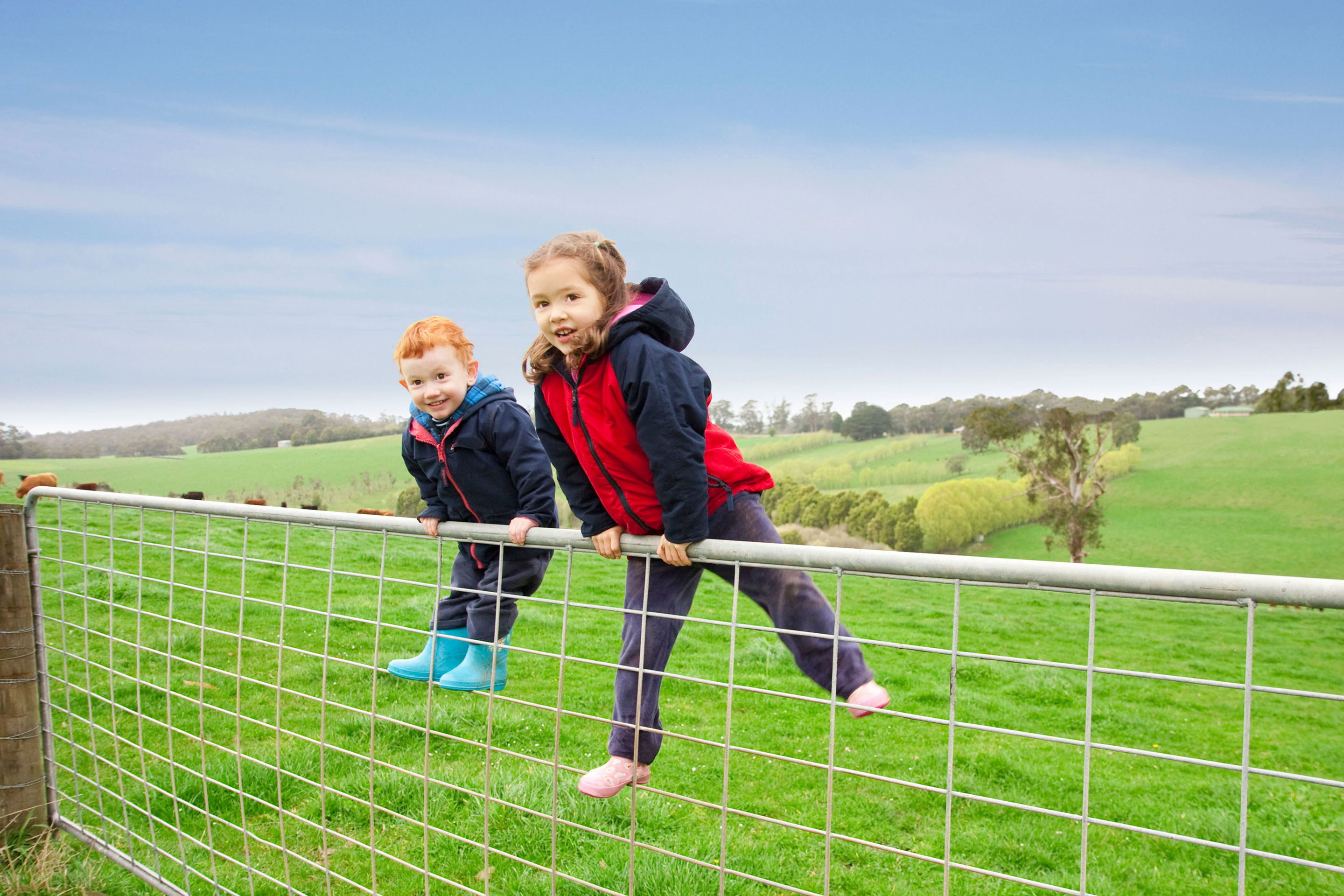 Kids climbing over fence